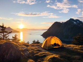Scenic sunset over mountain lake with camping tent