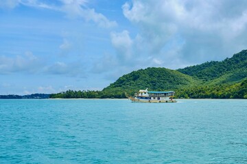 A passenger ferry en route to Chalong Pier on Phuket Island from Koh Racha Yai on a fine day with...