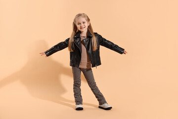 Fashion concept. Stylish girl posing on pale orange background