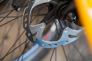 Close-up of a bicycle disc brake on a wheel with detailed view of the brake rotor and spokes, set...