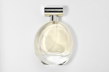 Luxury women's perfume in bottle on white background, top view