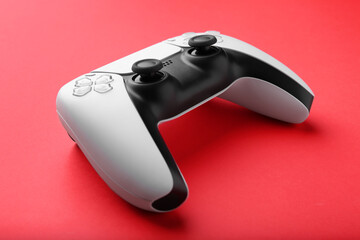 One wireless game controller on red background, closeup