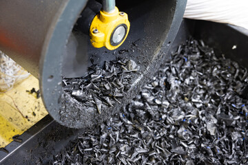 The process of industrial plastic shredding at a waste recycling plant. Converting waste into...