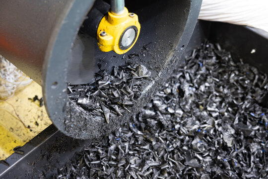 The process of industrial plastic shredding at a waste recycling plant. Converting waste into resources is the process of shredding plastic