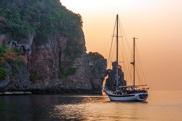 Yacht at sunset anchored in the bay of Phi Phi Don Island, Krabi, Thailand