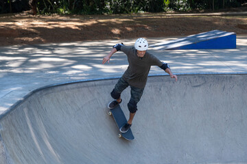 54 year old Brazilian skateboarder having fun at a skate park on a sunny day_10.