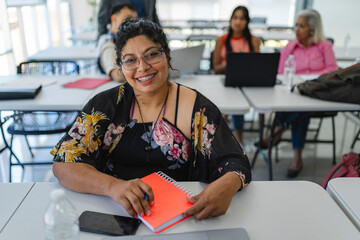 Portrait of a smiling Latina woman looking at the camera at the university. 