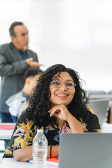 Portrait of a smiling Latina woman looking at the camera at the university. 