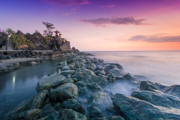 lots of rocks lined up close to the nuances of the sunset with slightly purplish and yellowish...