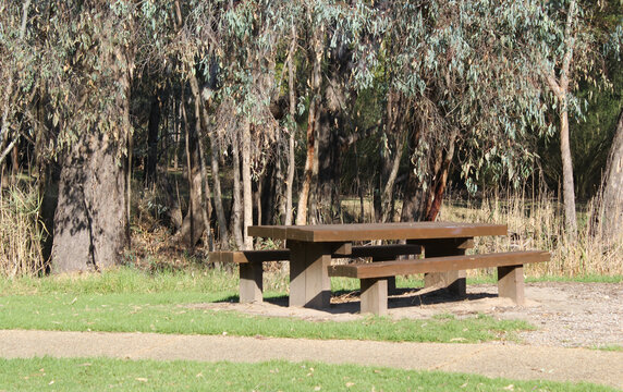 Picnic table bench with a pathway and trees at the Wonga Wetlands near Albury in New South Wales, Australia