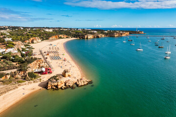Ferragudo with the Praia Grande (the main beach) and the river Rio Arade, Algarve, Portugal....