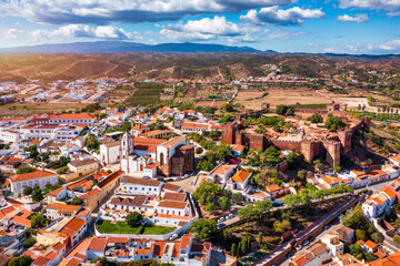 View of Silves town buildings with famous castle and cathedral, Algarve region, Portugal. Walls of...