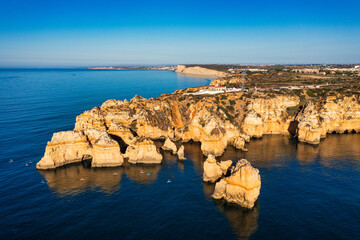 Panoramic view, Ponta da Piedade near Lagos in Algarve, Portugal. Cliff rocks and tourist boat on...