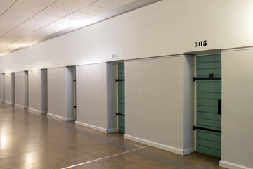 A row of cell doors in a prison corridor