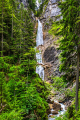 The beautiful three-part Lower Martuljek Waterfall in the Julian Alps, Slovenia. Triglav National Park. Scenic mountain with Martuljek waterfall in Triglav national park in Julian Alps, Slovenia.