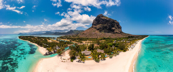 Beach with palm trees and umbrellas on Le morne beach in Mauriutius. Luxury tropical beach and Le...