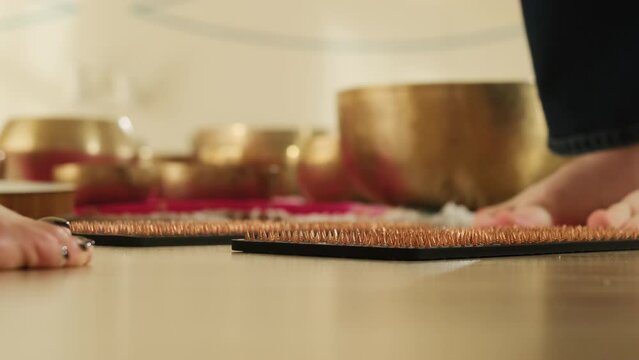 Client stands near Sadhu board opposite to instructor. Woman ready to embark on journey of inner exploration during meditation in studio