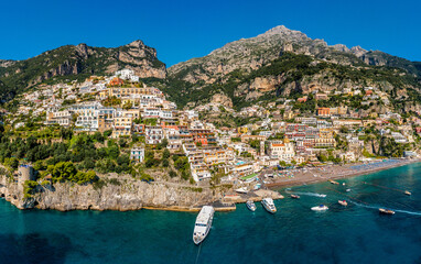 Aerial view of Positano with comfortable beach and blue sea on Amalfi Coast in Campania, Italy. Positano village on the Amalfi Coast, Salerno, Campania. Beautiful Positano, Amalfi Coast in Campania. - obrazy, fototapety, plakaty
