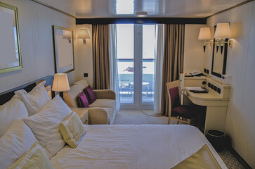 Luxurious ocean view balcony or verandah cabin on luxury cruiseship or cruise ship ocean liner in...
