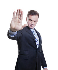 A successful businessman shows a stop sign gesture with his hand