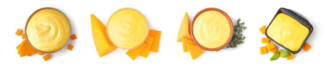 Set of bowls with tasty cheddar cheese sauce on white background, top view