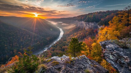 Amazing view of the New River Gorge in West Virginia, with the sun rising over the horizon and the autumn leaves turning the trees a vibrant orange and yellow. - obrazy, fototapety, plakaty