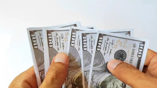 The hand of the man who counted the 100 dollar amarika bill
