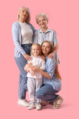 Little girl with her family on pink background