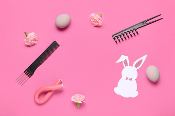 Frame made of hairdressing accessories with flowers, Ester eggs and bunny on pink background