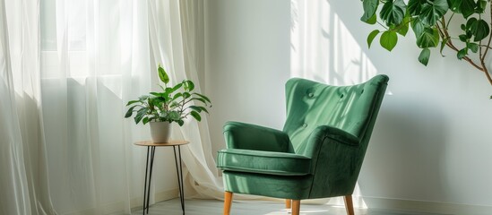Room with white walls containing a green armchair, small table, and plant