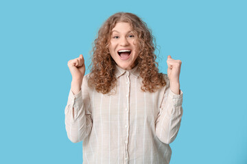 Beautiful happy young woman on blue background