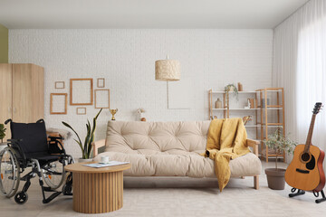 Interior of living room with wheelchair and sofa