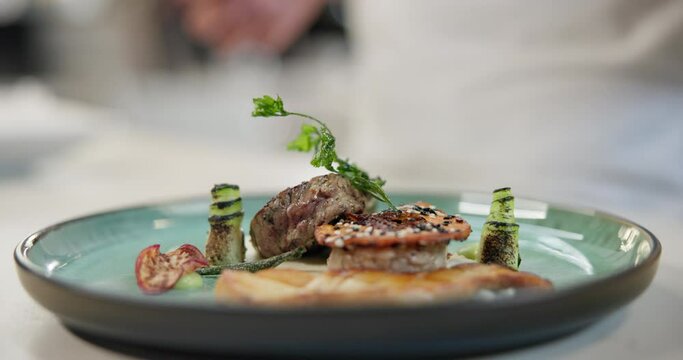 Luxury, restaurant and hand on plate with steak of gourmet menu with spices and herbs. Meat, beef and chef catering fine dining dinner with healthy protein, food or person cooking in kitchen at hotel