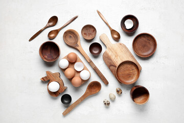Table setting with Easter eggs and wooden bunny on white background