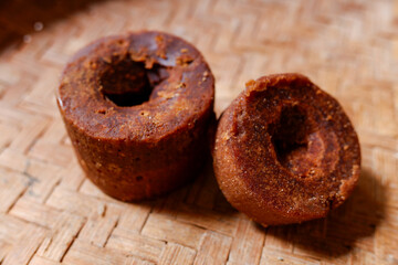 Gula jawa or Javanese sugar or palm sugar or brown sugar in a woven bamboo tray, flavor, stock photo.