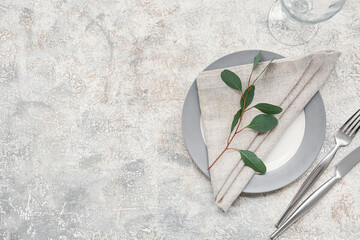 Beautiful table setting with leaves on grey background