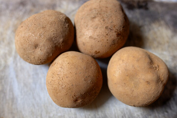 Freshly Harvested Potatoe on Woven Bamboo Tray, healthy food, stock photo.