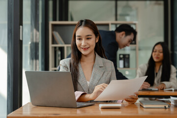 Obraz premium an employee is working in modern office and another coworkers are in the same room, working atmosphere in the office, businesspeople, work happily in the company