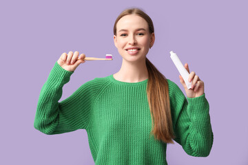 Young woman with tooth brush and paste on lilac background