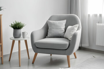 Cozy grey armchair with cushions in interior of light living room