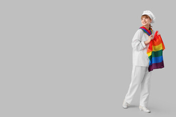 Female chef with LGBT flag on light background