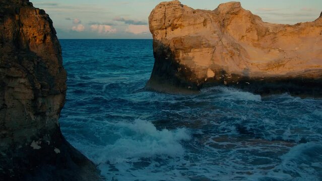 Waves crushing on beach rocks in Cleopatra bath Beach, a wonderful bay located on the opposite side of the biggest lagoon in Marsa Matrouh.
