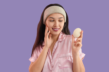 Young Asian woman with soap on lilac background, closeup