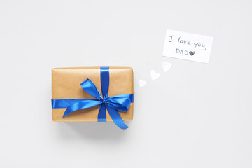 Gift box and paper with text I LOVE YOU, DAD on white background. Father's day celebration. Top view