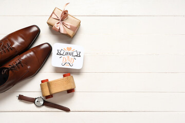 Paper with text I LOVE DAD, gift box and man's accessories on white wooden background. Father's day celebration. Top view