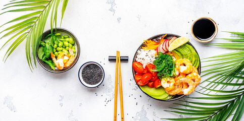 Balanced dier. Poke bowl with shrimp, rice, avocado, vegetables and chuka salad, white table...