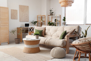 Interior of beautiful living room with comfortable sofa, coffee table and workplace