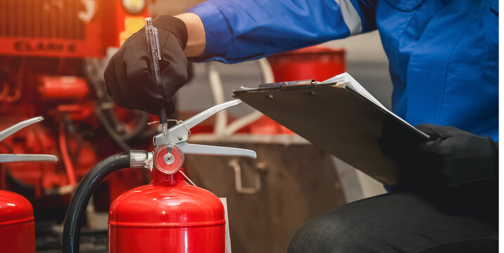 Engineer check fire extinguisher tank in the fire control room for safety in factory or industry.
