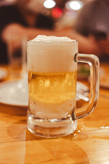 Glass of fresh cold beer on wood table