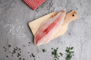 Fresh Dory Fish Fillet on Wooden Board Isolated on Gray Background 
